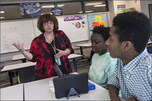 Teacher Robyn Lynn Howton works with students Maria Obuya (left) and Avery Jones at Mount Pleasant High School in Wilmington, Delaware on May 12, 2015. --Charles Mostoller for Education Week